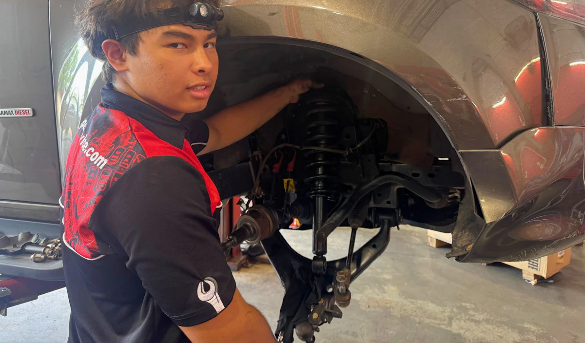Technician at Pauls Service Centre replacing front shock aborbers.